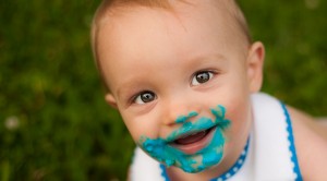 first birthday cake smash boy covered in frosting